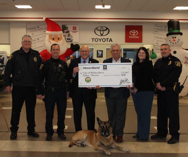  Wilkes-Barre City Police Chief Joseph Coffay, Wilkes-Barre City K-9 Unit Handler/Trainer Joseph Homza, Wilkes-Barre City Mayor George C. Brown, MotorWorld | MileOne Autogroup Division President Rick Osick, MotorWorld Customer Relations Manager, Shelley Puzzetti, Wilkes-Barre City Captain Michael Boyle, and WBPD K-9 Chase.